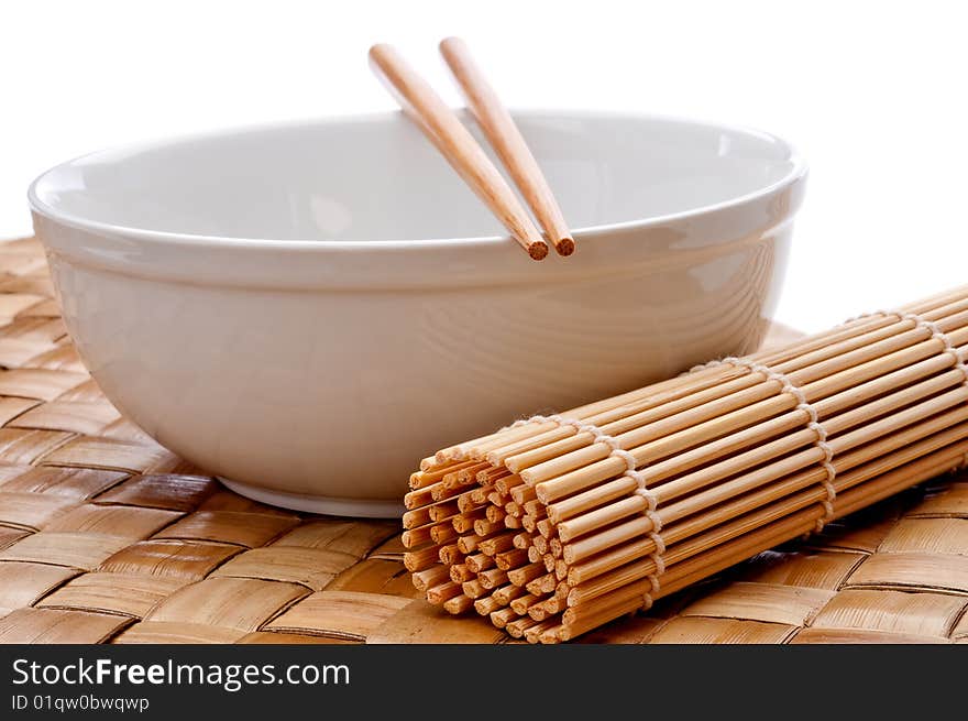 A pair of chopsticks on a white bowl