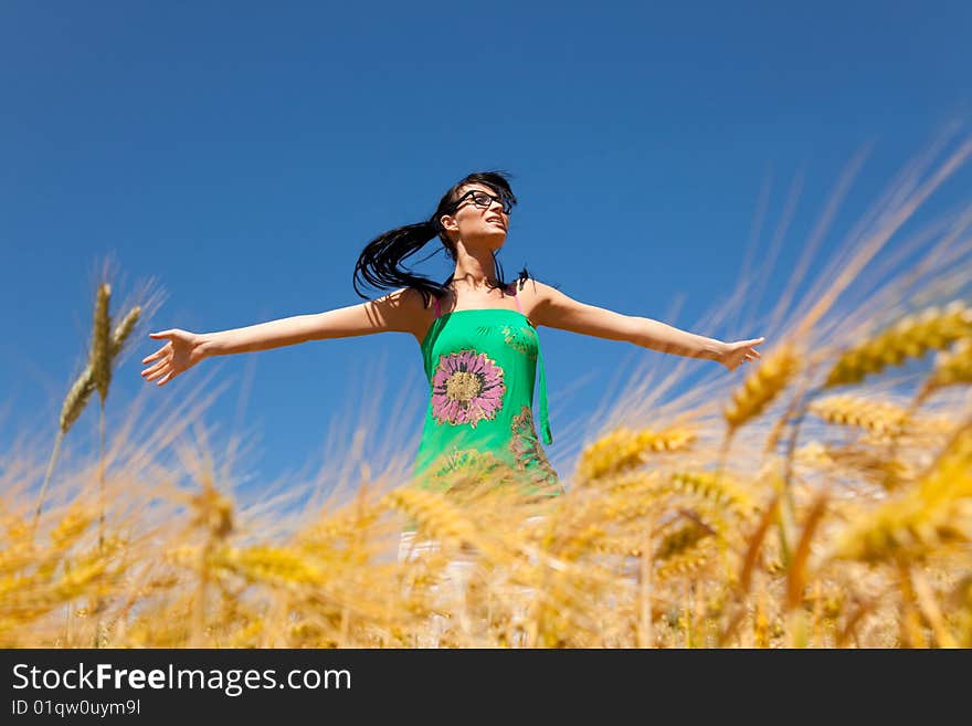 Happy woman with outstretched arms in field. Happy woman with outstretched arms in field