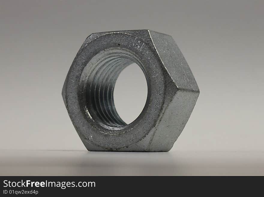 A large zinc plated steel nut. A large zinc plated steel nut.