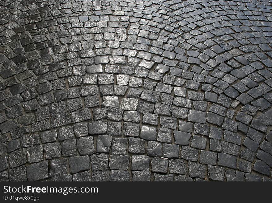 Part of a cobblestone pavement after the rain