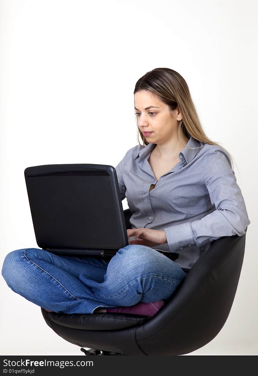 Young girl, writes in her computer. Young girl, writes in her computer