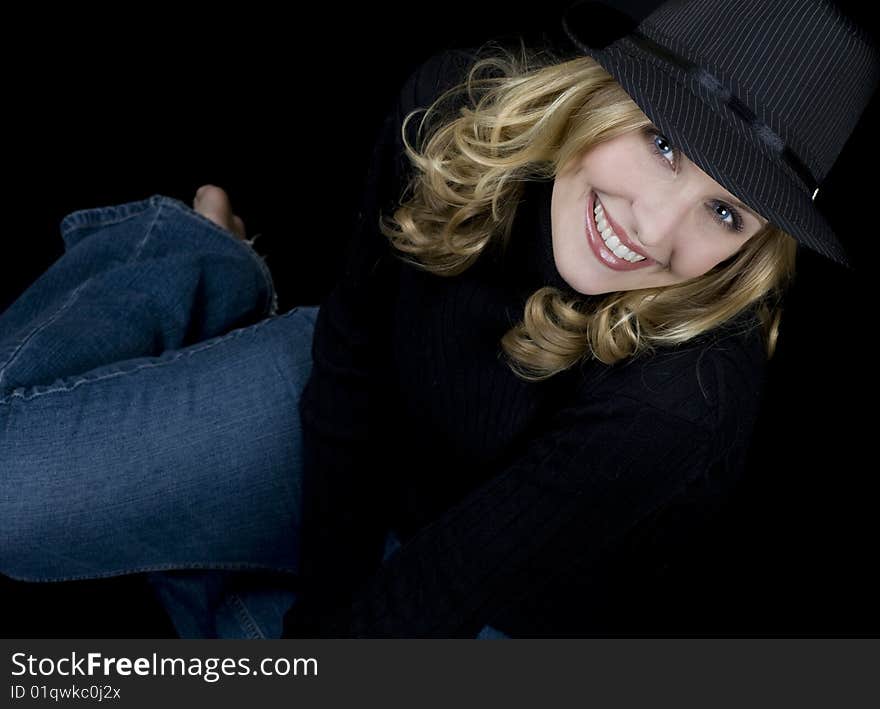 Beautiful blue eyed blond wearing a black hat. Beautiful blue eyed blond wearing a black hat.