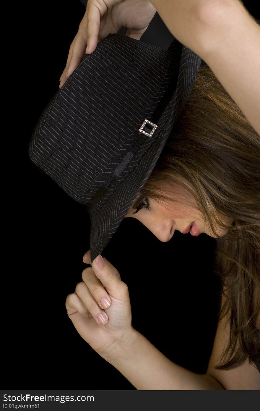 Attractive brunette posing in a black pin striped hat. Attractive brunette posing in a black pin striped hat