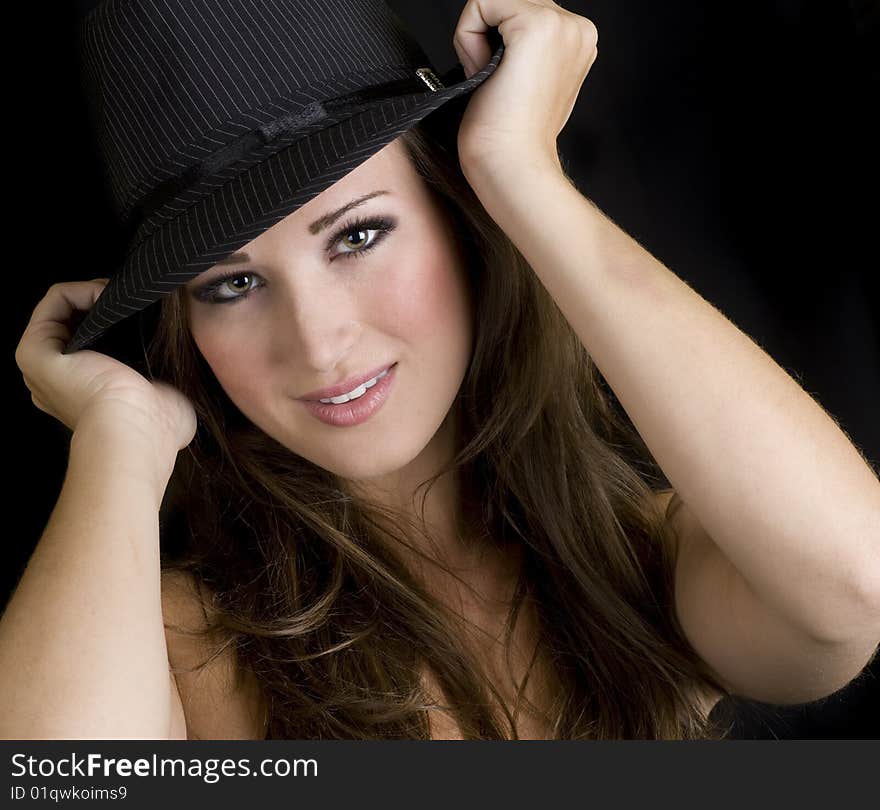 Square portrait of a beautiful brunette woman wearing a hat. Square portrait of a beautiful brunette woman wearing a hat