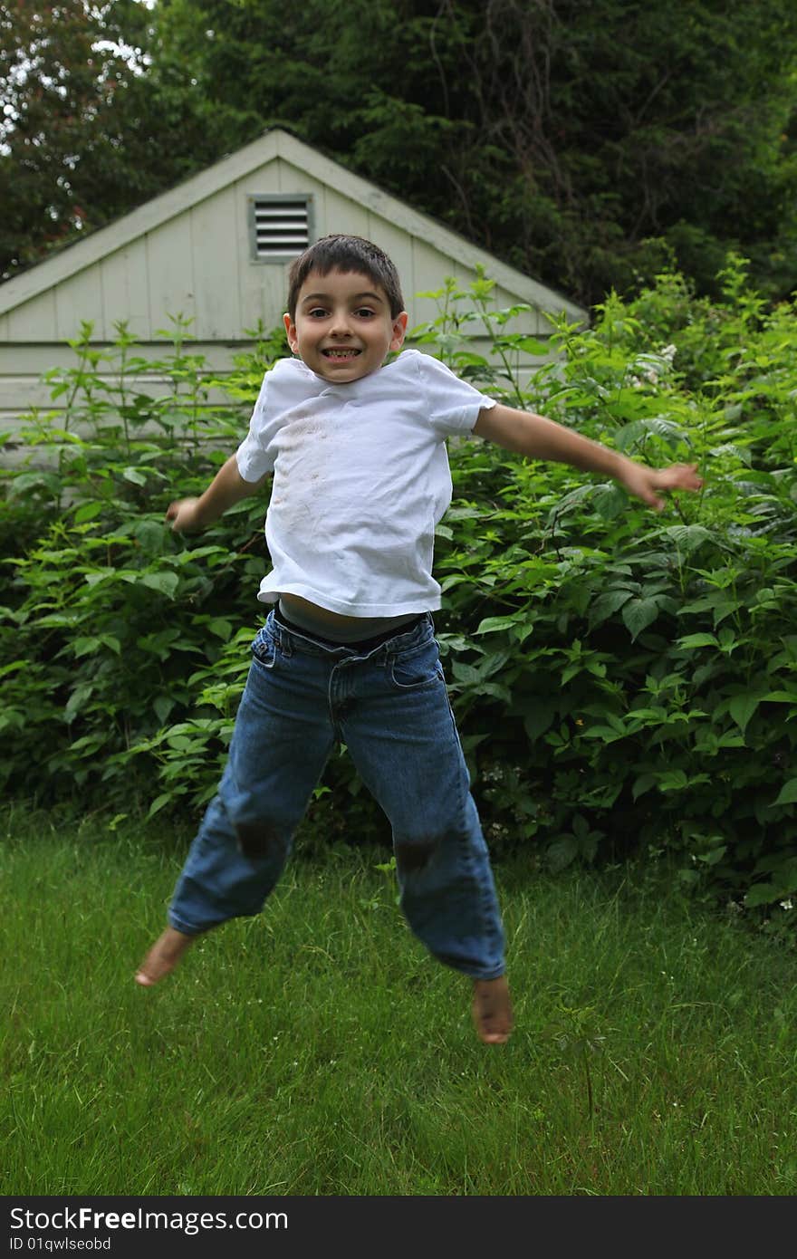 Filthy caucasian boy playing outside.  Covered in dirt.