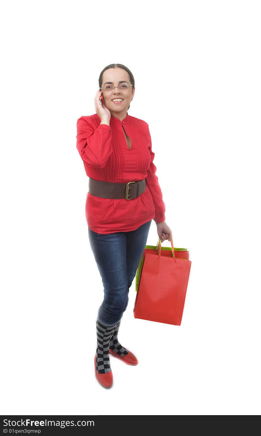 Lady in red with red shopping bag talking by phone. Lady in red with red shopping bag talking by phone