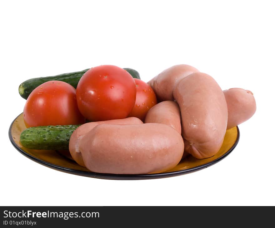 Small sausages with vegetables on a dish