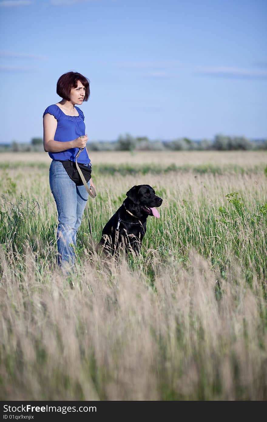 Woman with  dog in field. Woman with  dog in field