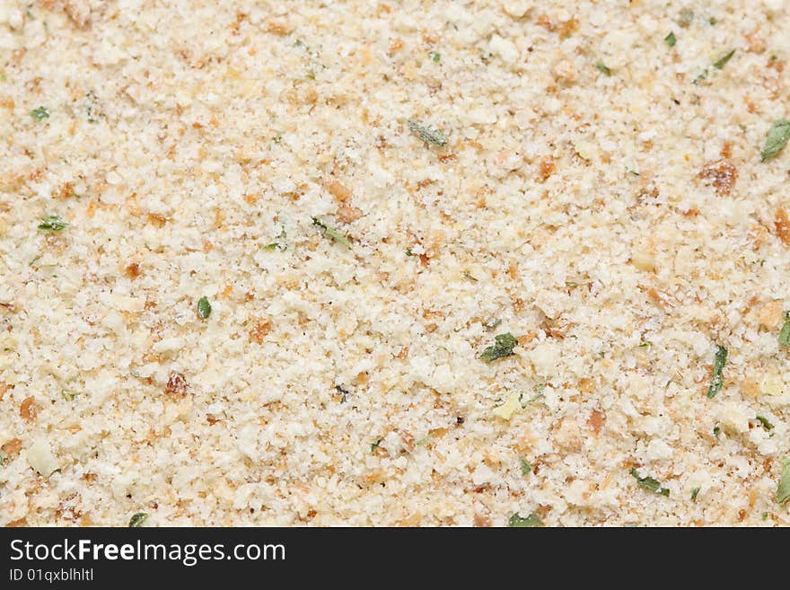 A macro shot of a heap of seasoned bread crumbs.