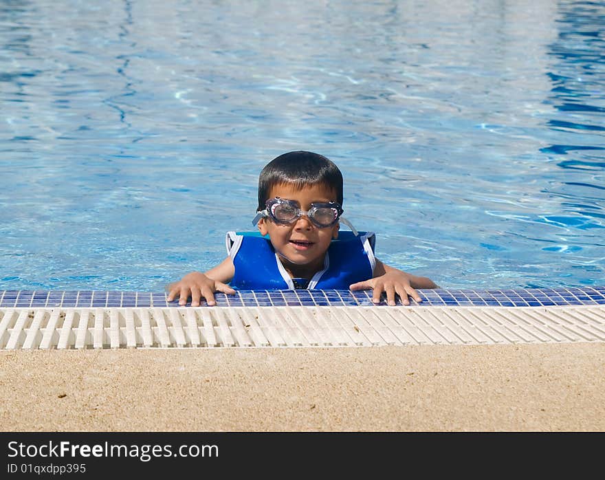 The boy bathes in the summer in pool