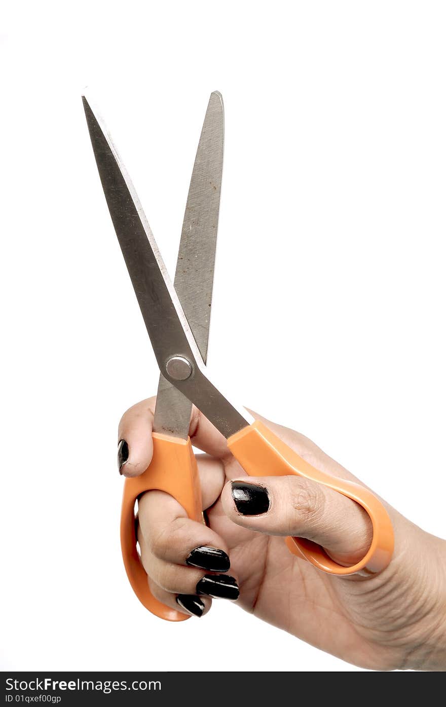 Female hand with orange scissor.