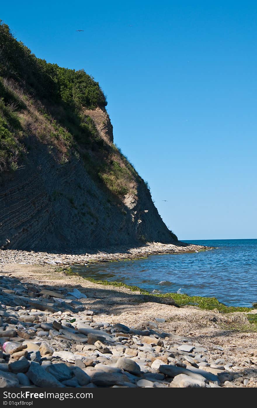 Rock on a deserted stony beach near the black sea