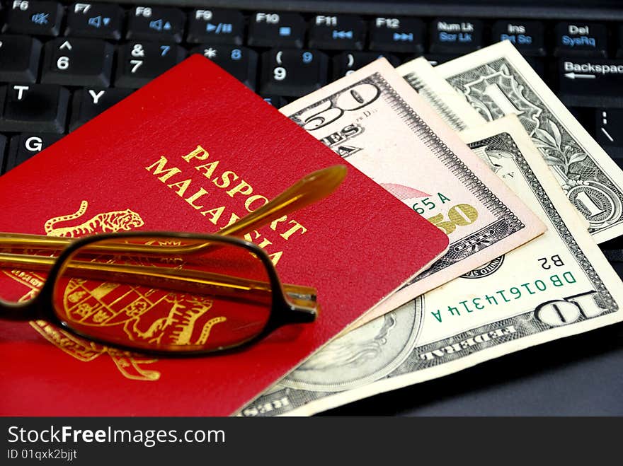 International Travel Passport with Currency put on top computer. International Travel Passport with Currency put on top computer