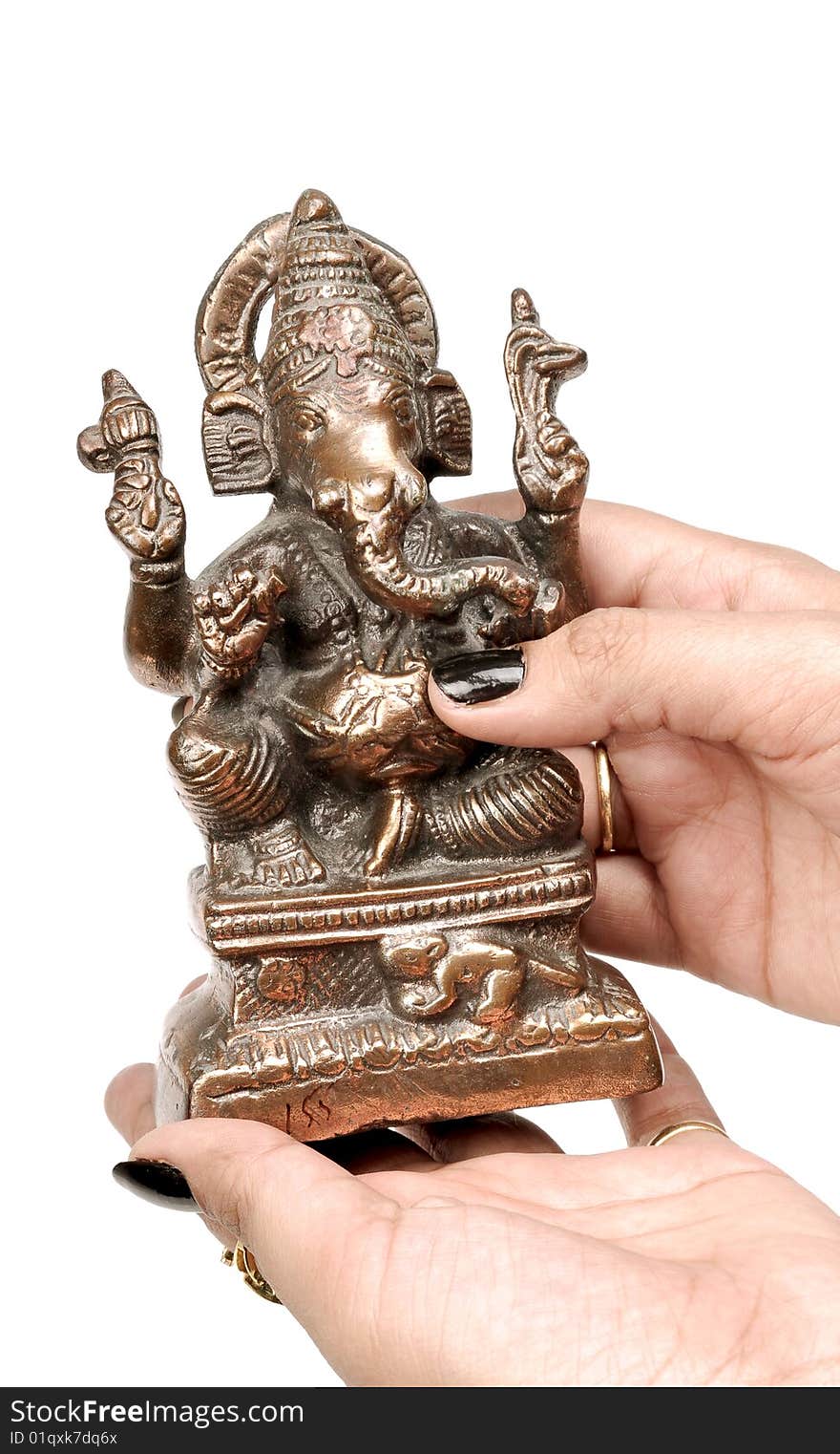 Female hand holding Ganesh statue.