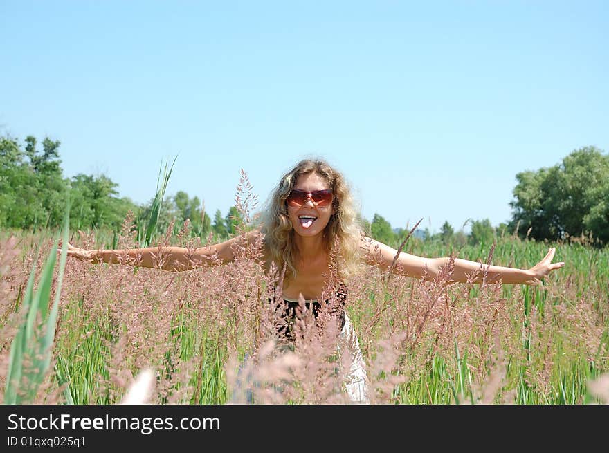 Adorable young woman jumping in the floral field. Adorable young woman jumping in the floral field