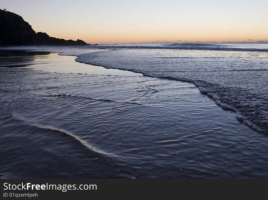 Sunrise in the calm waves of a beach. Sunrise in the calm waves of a beach