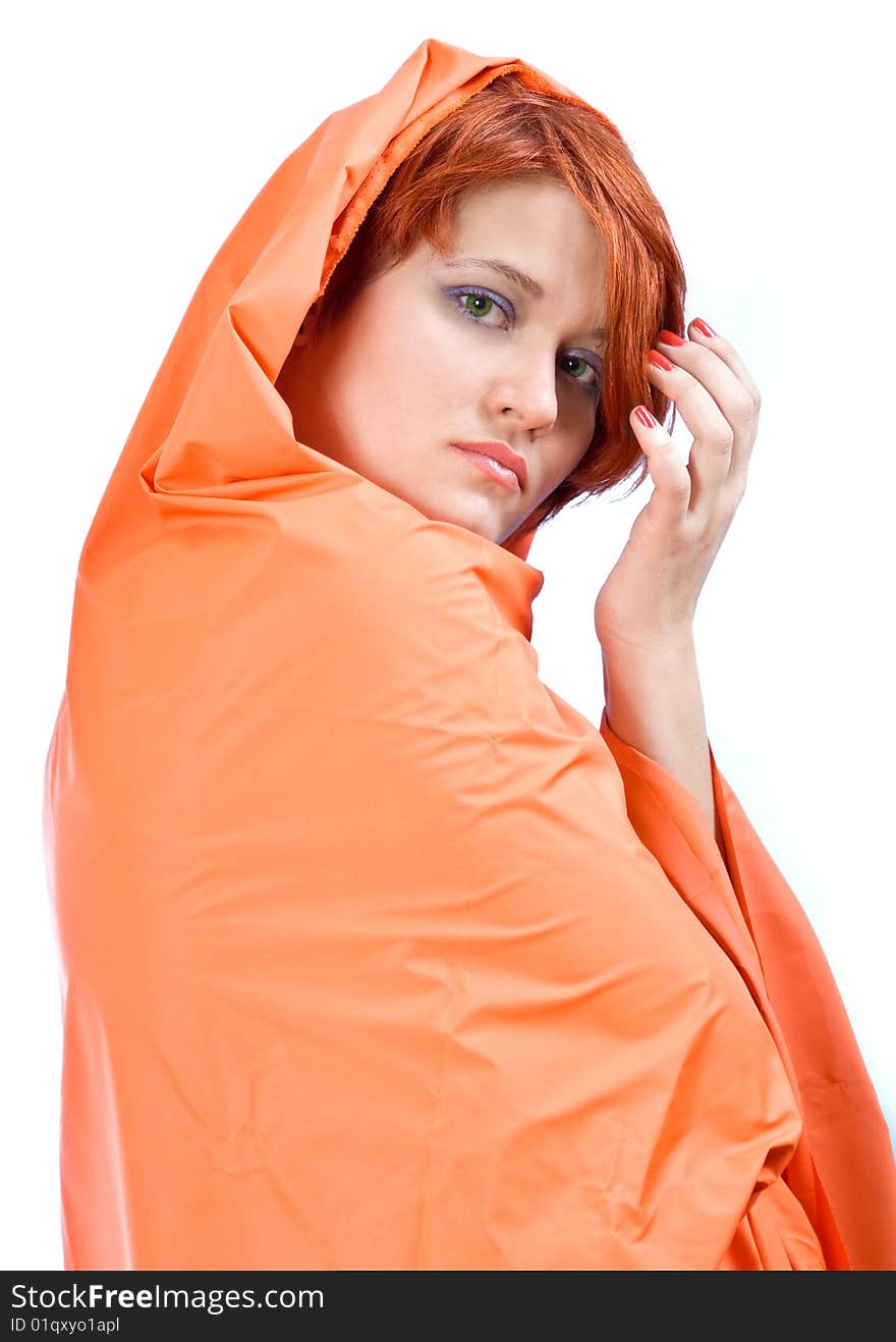 Red-haired girl in red cover on a white background. Red-haired girl in red cover on a white background