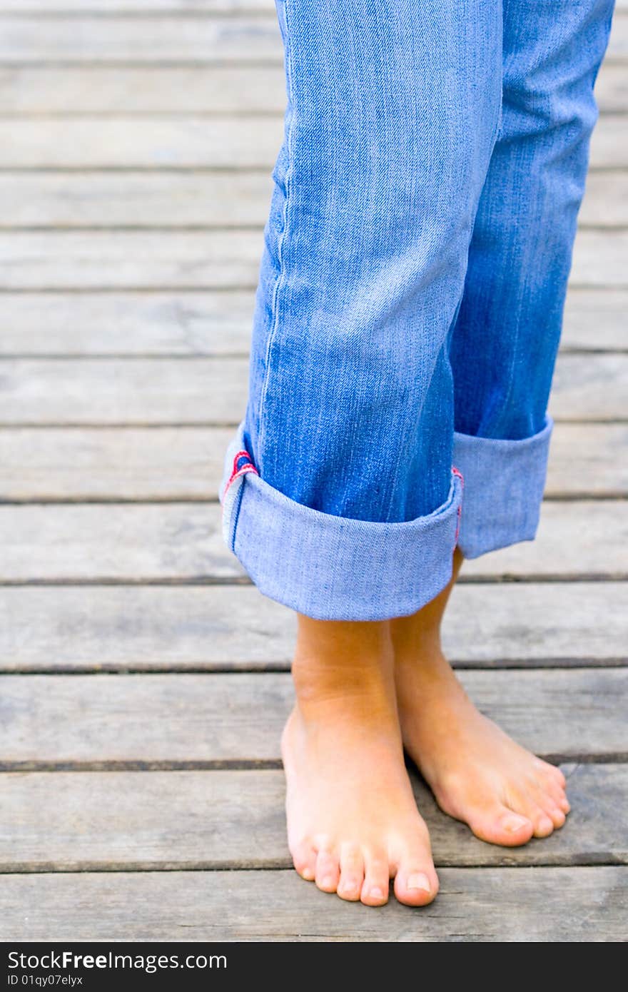 Female legs standing on toes on a wooden floor