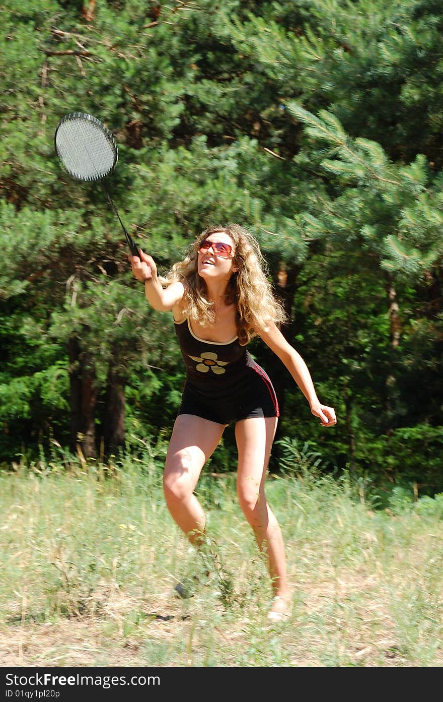 Beautiful young woman playing badminton outdoor. Beautiful young woman playing badminton outdoor