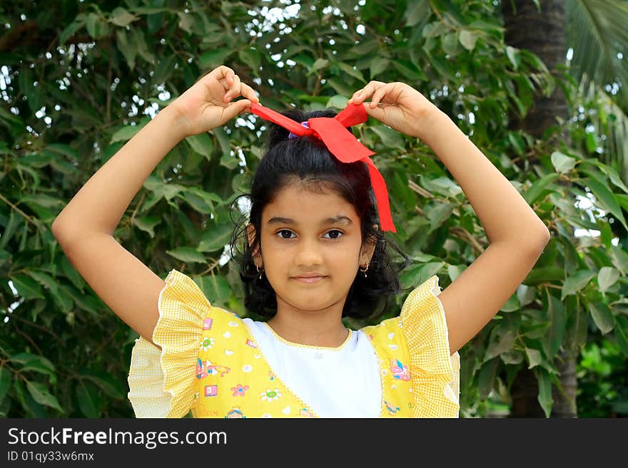 Girl untying her ribbon.