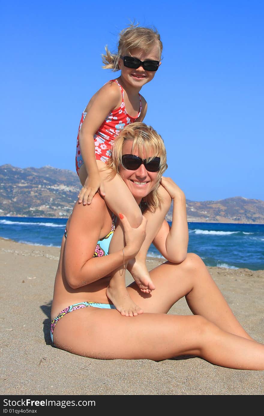 Happy mum with a daughter have a rest on the sea