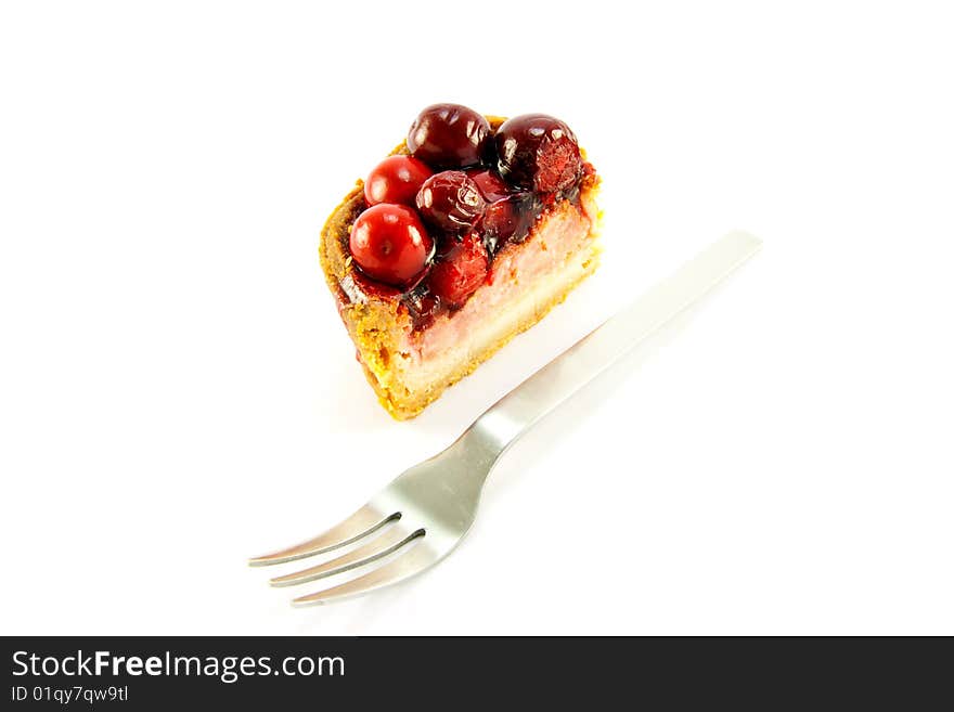 Slice of pork pie and a fork with clipping path on a white background. Slice of pork pie and a fork with clipping path on a white background