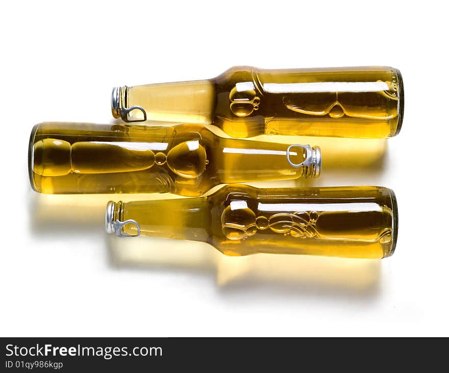 three bottle of beer with shadows on a white background