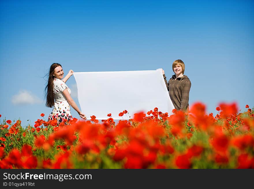 Lovely couple in the poppy field, copy-space for your text