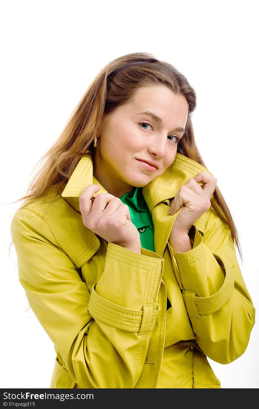 A pretty young woman in a yellow raincoat, isolated on white. A pretty young woman in a yellow raincoat, isolated on white