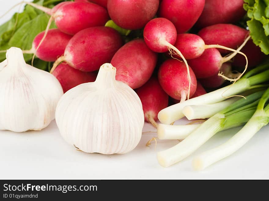 Spring onions, garlic, lettuce and radish bunch on the white background