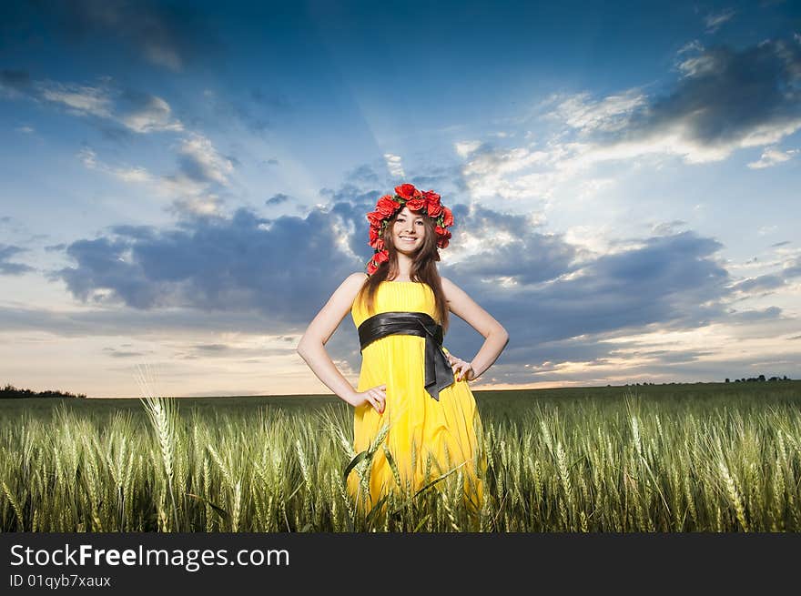 Beautiful young girl in the wheat field