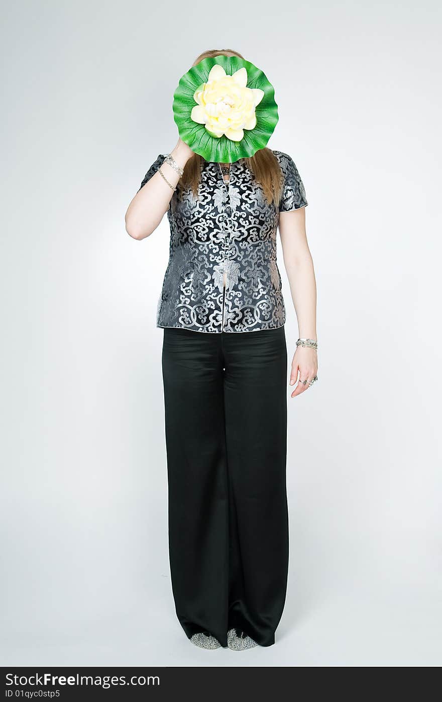 Woman with lotus flower, studio shot