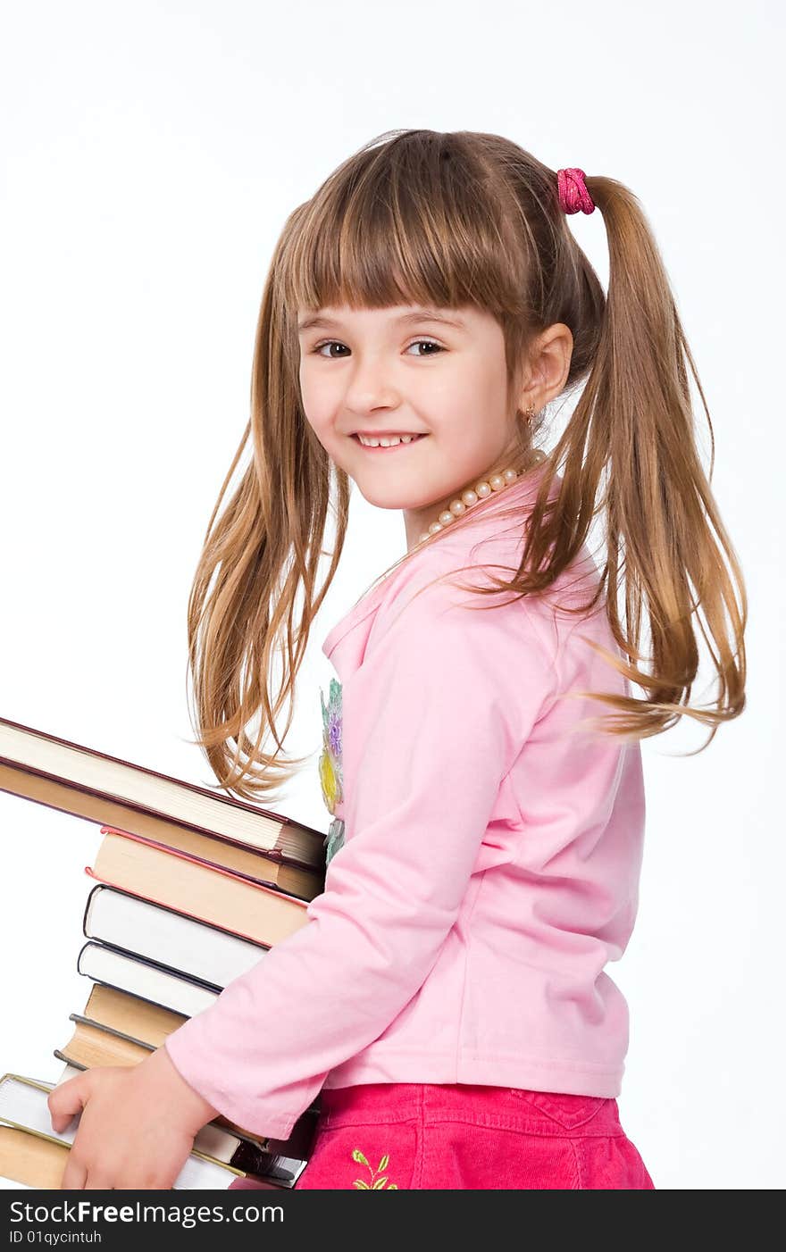 Pretty little girl holding stack of books