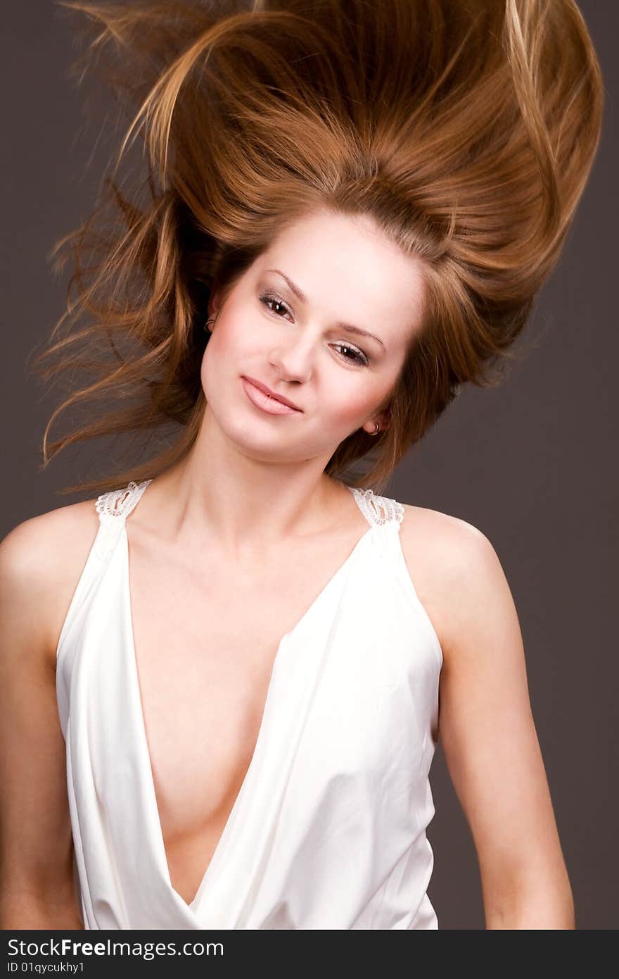 Happy young  girl with long flying hair