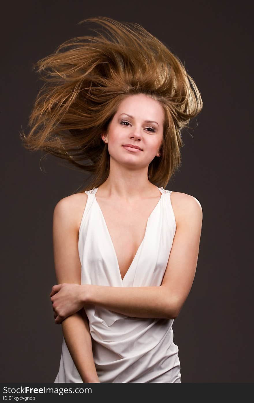 Happy young girl with long flying hair