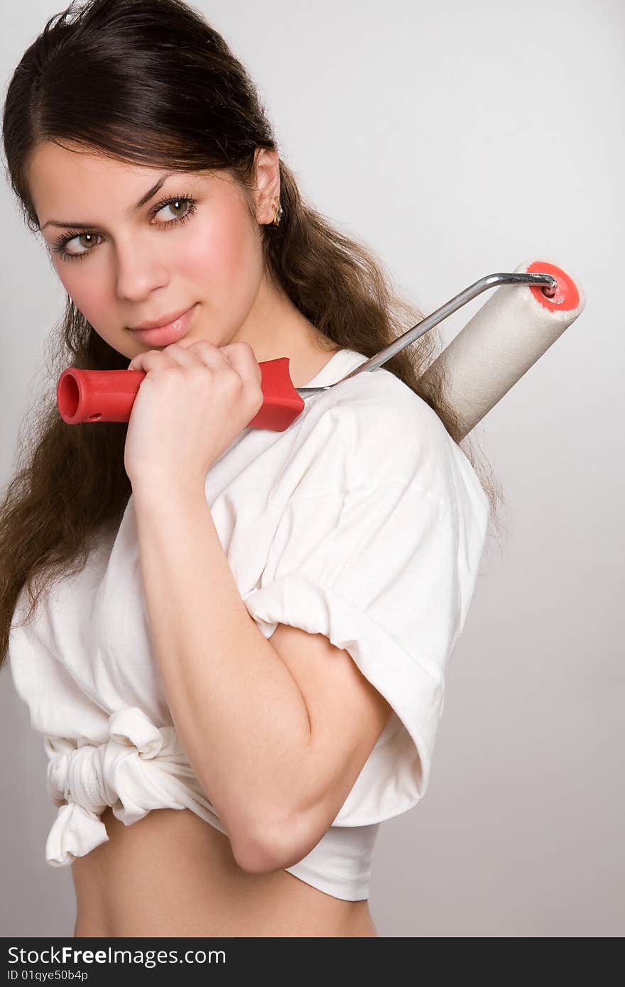 Pretty young woman with painting roller. Pretty young woman with painting roller