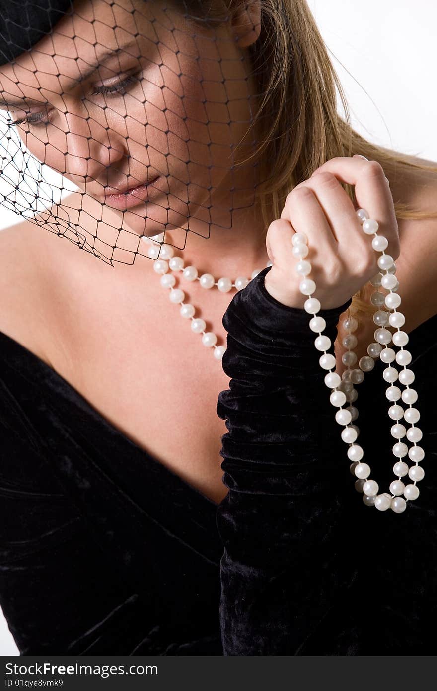 Portrait of elegant young lady in black with veil and beads. Portrait of elegant young lady in black with veil and beads