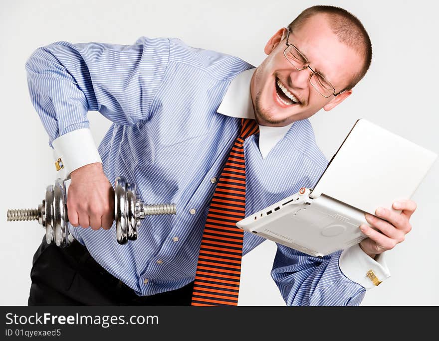 Businessman lifting dumbbell with laptop. Businessman lifting dumbbell with laptop