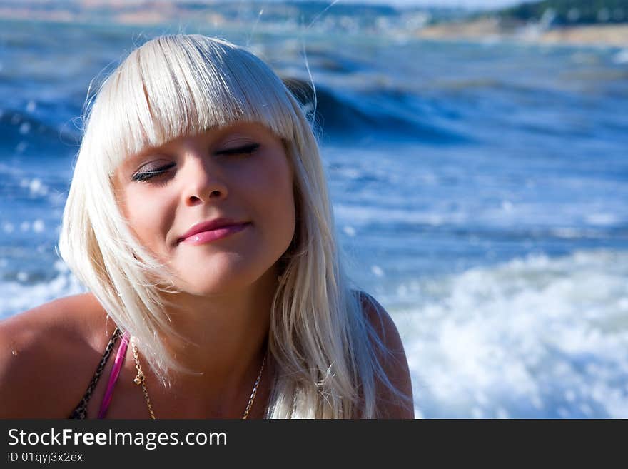 The beautiful blonde the girl against the sea