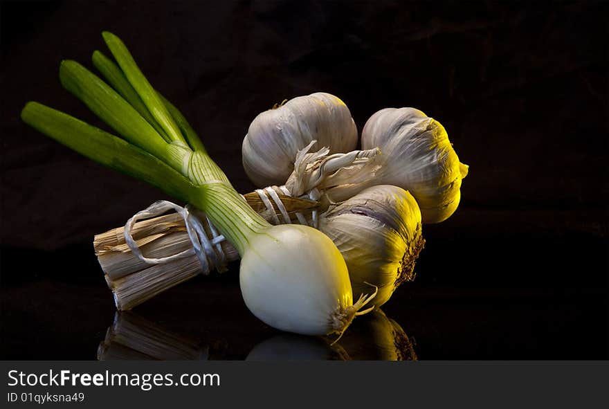 Garlic & Spring Onion on black marble worktop