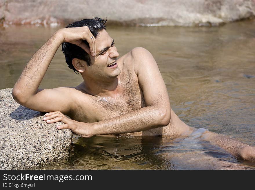 Happy young man enjoying and relaxing  on the river. Happy young man enjoying and relaxing  on the river