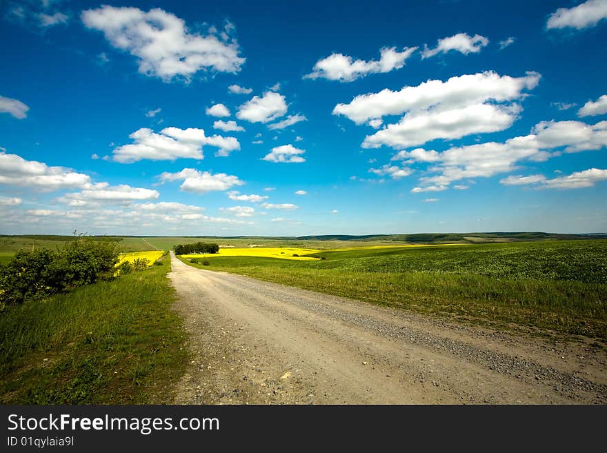An image of  road in the field and blue sky. An image of  road in the field and blue sky