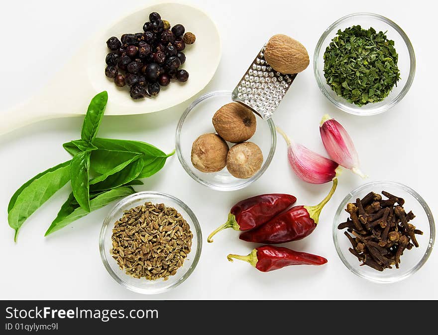 Different spices on the table on white