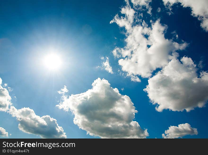 White fluffy clouds in the blue sky in summertime. White fluffy clouds in the blue sky in summertime