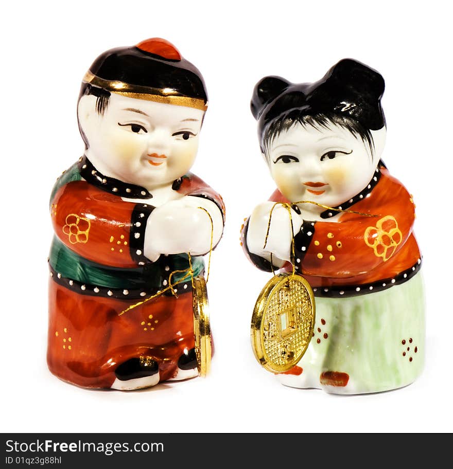 Oriental motif. Close up image of two porcelain figurines isolated on white.