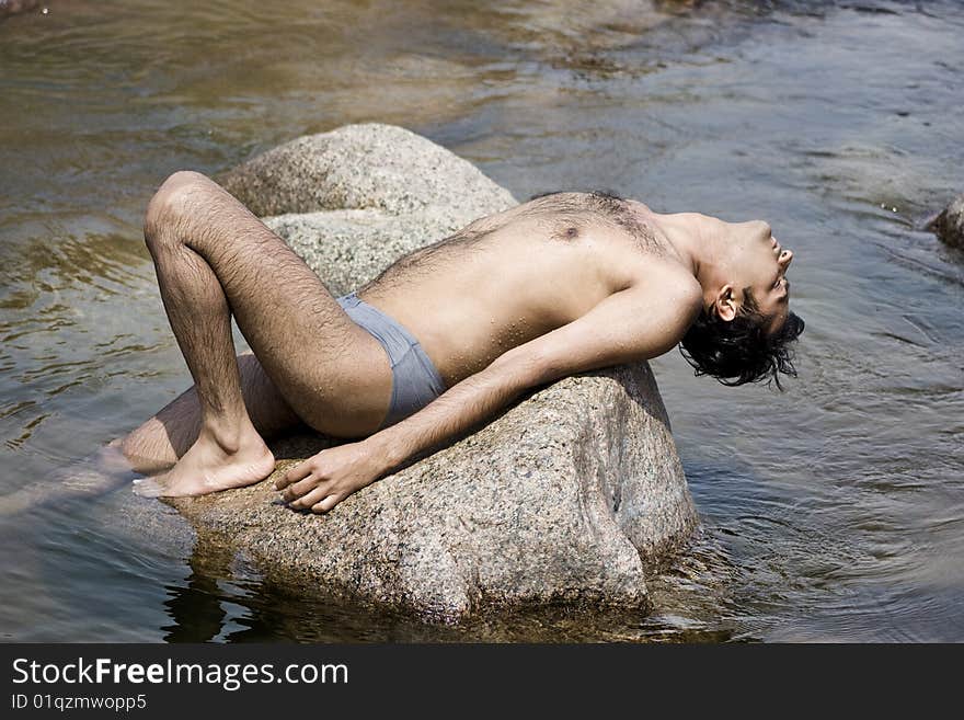 Man taking rest and closed eyes  over stone. Man taking rest and closed eyes  over stone