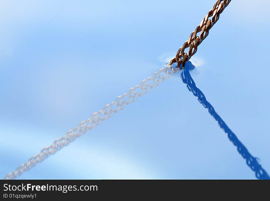 Abstract blue water background with gold chain. Abstract blue water background with gold chain