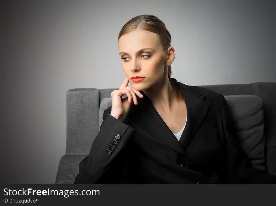 Portrait of beautiful business woman sitting on armchair