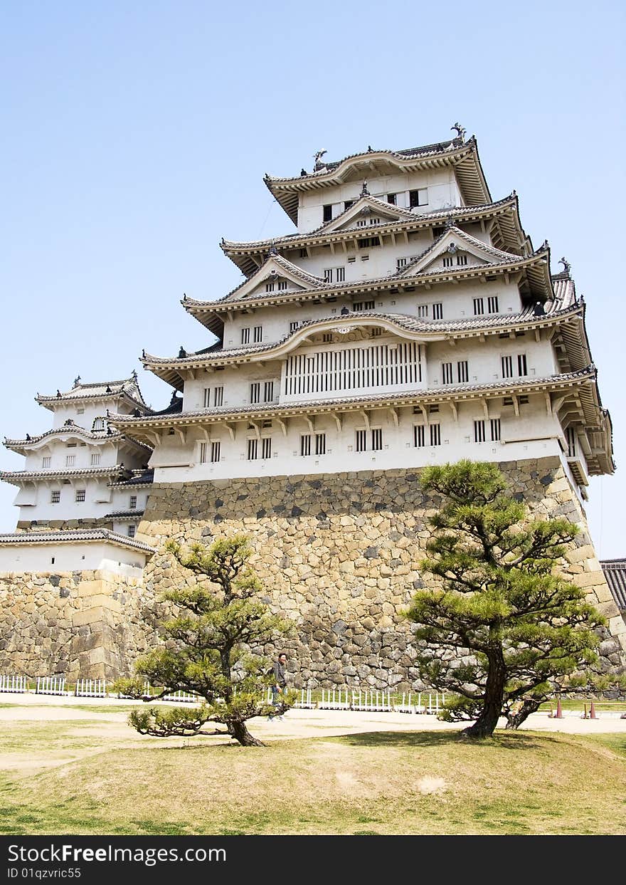 Himeji castle front view from the main hill with a couple of trees. Himeji castle front view from the main hill with a couple of trees