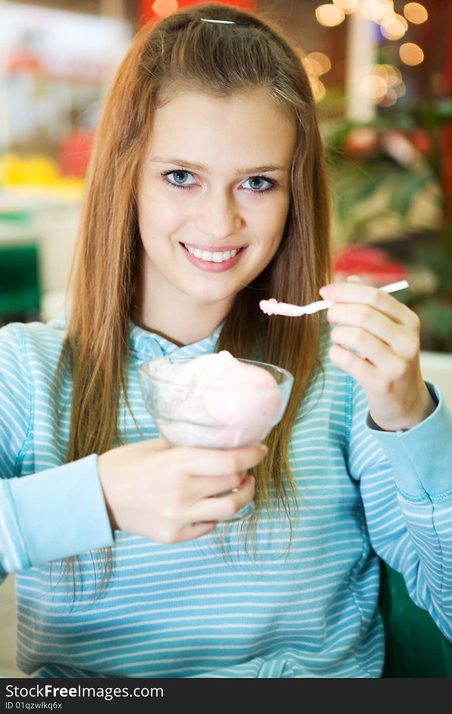 Young woman with ice cream indoor